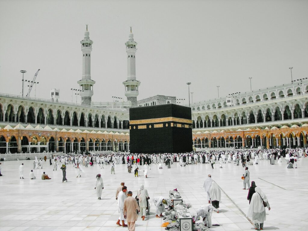 a group of people standing around a large building